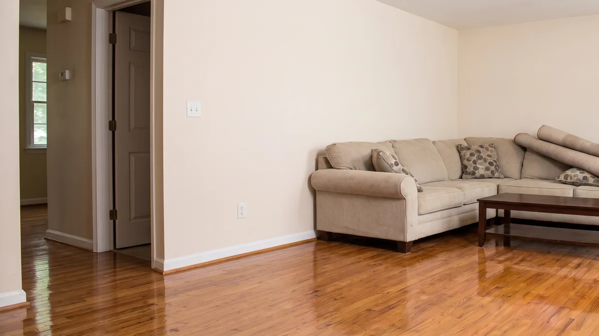 Living room water removal and restoration, After: Matching living room after restoration, with clean walls, hardwood flooring, and furniture back in place